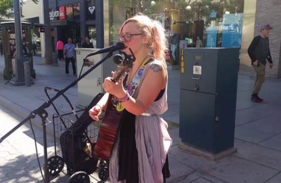 Aspiring musician Alana Nabors performs her original song 'In Love With Love' on Santa Monica's Third Street Promenade on Tuesday